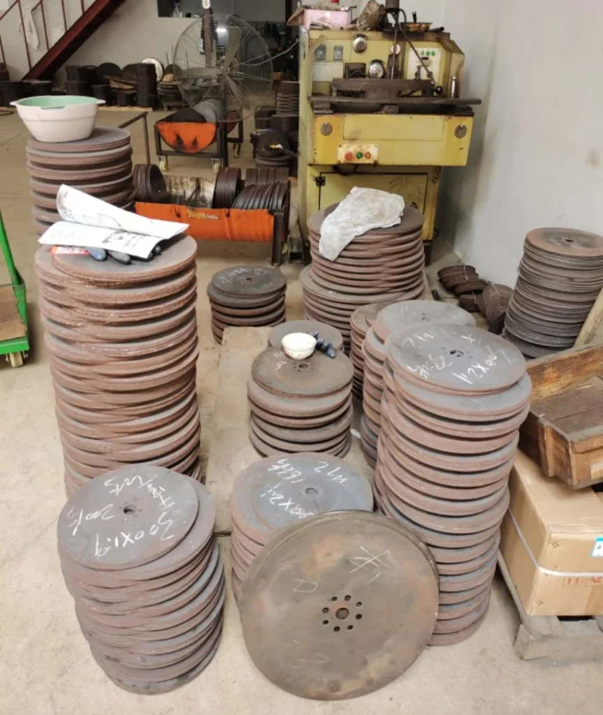 Stacks of circular saw blades on a workshop floor